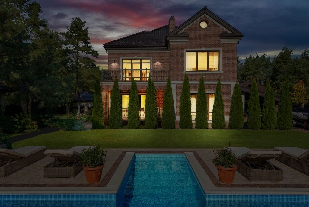 House at dusk with exterior and landscape lighting