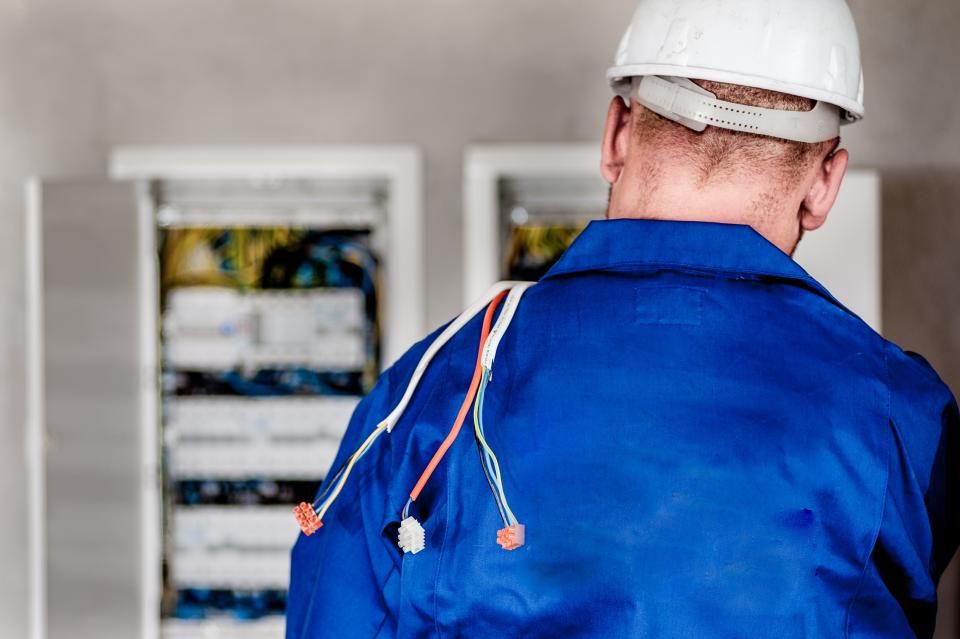 Electrician working on a breaker panel