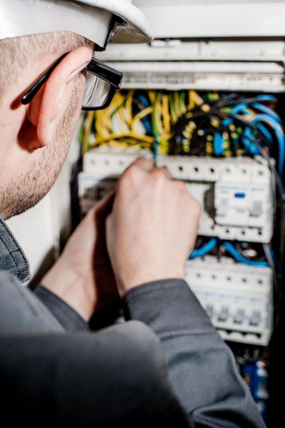 Electrician wiring breakers inside a panel