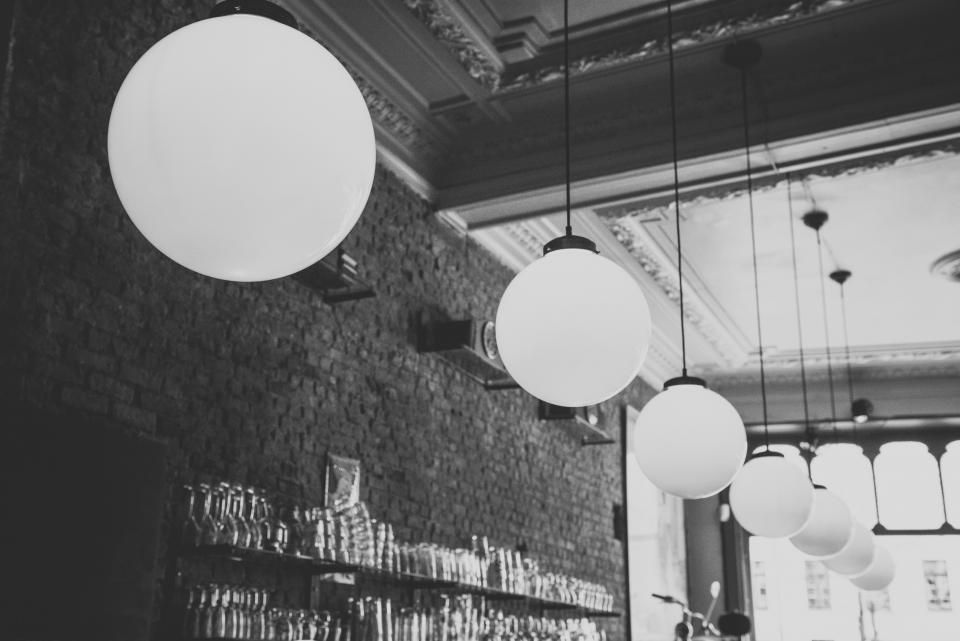 Globe pendant lights in a brick-walled room